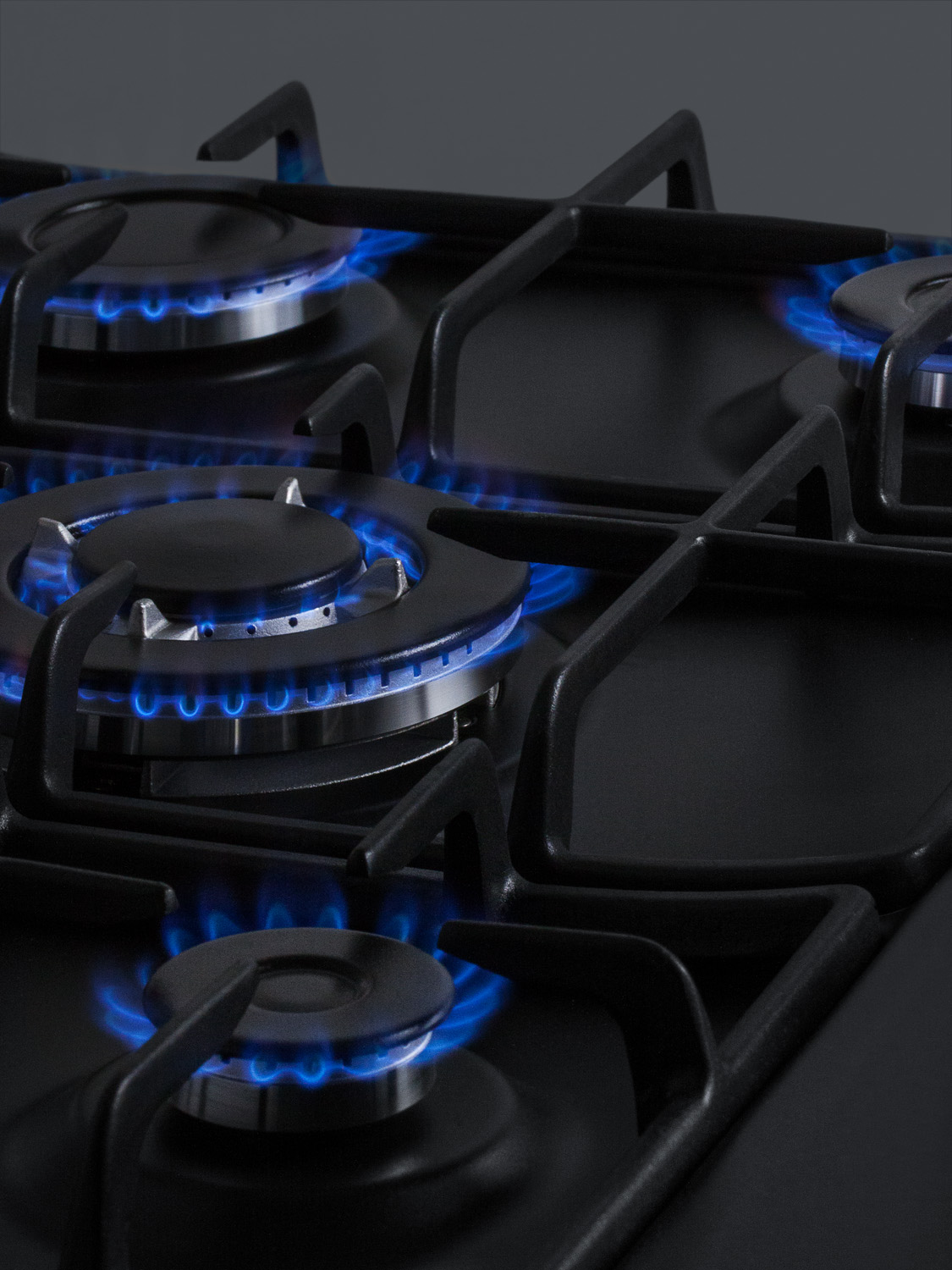5-burner gas cooktop made in Italy in a black matte finish with sealed burners, cast iron grates, and wok stand; fits standard 24